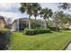 Home with a screened patio and lush landscaping at 13240 Guyana St, Venice, FL 34293