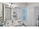 Clean bathroom with a tub shower and a glass block window at 13240 Guyana St, Venice, FL 34293