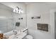 Clean bathroom with a single sink vanity, shower, and linen storage at 13240 Guyana St, Venice, FL 34293