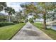 Scenic walking path with lake views and lush landscaping at 13240 Guyana St, Venice, FL 34293