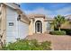 Tan house with tile roof, white garage door, and nicely landscaped yard at 13240 Guyana St, Venice, FL 34293