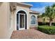 White front door with arched entryway and decorative screen at 13240 Guyana St, Venice, FL 34293