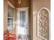 Front entry with white door, red bench, and decorative wall art at 13240 Guyana St, Venice, FL 34293
