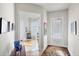 Hallway with access to office and exterior door, featuring neutral color scheme at 13240 Guyana St, Venice, FL 34293