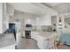 Modern kitchen with white cabinetry, stainless steel appliances, and ample counter space at 13240 Guyana St, Venice, FL 34293