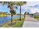 Peaceful waterway and bridge with lush landscaping and palm trees at 13240 Guyana St, Venice, FL 34293