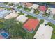 Aerial view of houses with red tile roofs in a residential neighborhood at 135 Braemar Ave, Venice, FL 34293