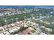 Aerial view of community near a lake, showing various houses and streets at 135 Braemar Ave, Venice, FL 34293