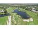 Aerial view of golf course community with lush landscaping and ponds at 135 Braemar Ave, Venice, FL 34293