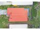 Aerial view of home with red tile roof, landscaped yard, and screened enclosure at 135 Braemar Ave, Venice, FL 34293
