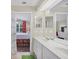 Bathroom with double vanity, shower, and view of bedroom at 135 Braemar Ave, Venice, FL 34293