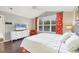 Main bedroom with king bed, media console, and orange curtains at 135 Braemar Ave, Venice, FL 34293