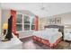 Main bedroom with king-size bed, large windows, and ceiling fan at 135 Braemar Ave, Venice, FL 34293