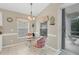 Cozy breakfast nook with glass table and pink chairs near sliding door at 135 Braemar Ave, Venice, FL 34293