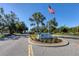 Entrance to Wexford On The Green community with flag and landscaping at 135 Braemar Ave, Venice, FL 34293