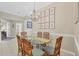 Bright dining room with glass-top table and bamboo chairs at 135 Braemar Ave, Venice, FL 34293