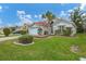 Single-story home with tile roof, landscaping, and a two-car garage at 135 Braemar Ave, Venice, FL 34293