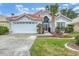 House with tile roof and landscaping, featuring a two-car garage at 135 Braemar Ave, Venice, FL 34293