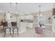 Kitchen features white cabinetry, breakfast bar, and a small dining table at 135 Braemar Ave, Venice, FL 34293