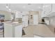 Modern kitchen with white cabinets, breakfast bar, and tile flooring at 135 Braemar Ave, Venice, FL 34293