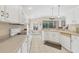 Open kitchen with white cabinets, ample counter space, and island at 135 Braemar Ave, Venice, FL 34293