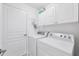 Laundry room with washer, dryer, and cabinets at 135 Braemar Ave, Venice, FL 34293
