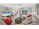 Spacious living room with sectional sofa, large TV, and sliding glass doors at 135 Braemar Ave, Venice, FL 34293