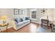 Home office with comfortable sofa, work desk, and hardwood floors at 135 Braemar Ave, Venice, FL 34293