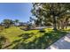 Community playground with playset, slide, and shaded bench at 135 Braemar Ave, Venice, FL 34293