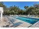 Community swimming pool with plenty of lounge chairs for sunbathing at 135 Braemar Ave, Venice, FL 34293