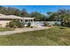 Community pool with pergola, lounge chairs, and surrounding landscaping at 135 Braemar Ave, Venice, FL 34293