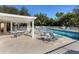 Inviting community pool area with pergola, tables, and chairs at 135 Braemar Ave, Venice, FL 34293