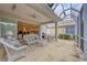 Spacious screened porch, wicker furniture, view of kitchen at 135 Braemar Ave, Venice, FL 34293