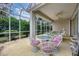 Relaxing screened patio with seating area and grill, overlooking backyard at 135 Braemar Ave, Venice, FL 34293