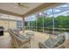 Relaxing screened porch with wicker furniture at 135 Braemar Ave, Venice, FL 34293