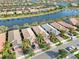 Five houses on a waterfront street, with palm trees and driveways at 13864 Posada St, Venice, FL 34293