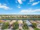 Five houses on a waterfront street, with palm trees and driveways at 13864 Posada St, Venice, FL 34293