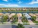 Five houses on a waterfront street, with palm trees and driveways at 13864 Posada St, Venice, FL 34293