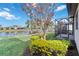 Backyard oasis featuring a pond, manicured lawn, and screened porch at 13864 Posada St, Venice, FL 34293