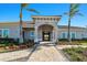 Community clubhouse with walkway and landscaping, featuring Spanish architecture at 13864 Posada St, Venice, FL 34293