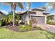 House exterior with a gray garage door and palm trees at 13864 Posada St, Venice, FL 34293
