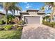 Single-story house with a two-car garage and landscaped front yard at 13864 Posada St, Venice, FL 34293