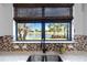 Kitchen sink with a view of water and palm trees at 13864 Posada St, Venice, FL 34293