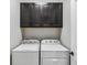 Laundry room with washer, dryer and upper cabinets at 13864 Posada St, Venice, FL 34293