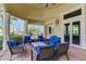 Community lounge with blue couches and wicker chairs, screened patio at 13864 Posada St, Venice, FL 34293
