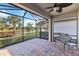 Screened porch with lake view and ceiling fan at 13864 Posada St, Venice, FL 34293