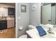 Guest bathroom with toilet and vanity; kitchen view at 140 Columbia Rd, Venice, FL 34293