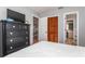 Bedroom with dresser, TV, and view of the dining area at 140 Columbia Rd, Venice, FL 34293