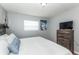 Bedroom with king-size bed, dresser, and large TV at 140 Columbia Rd, Venice, FL 34293