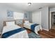 Guest bedroom with two twin beds and wood floors at 140 Columbia Rd, Venice, FL 34293